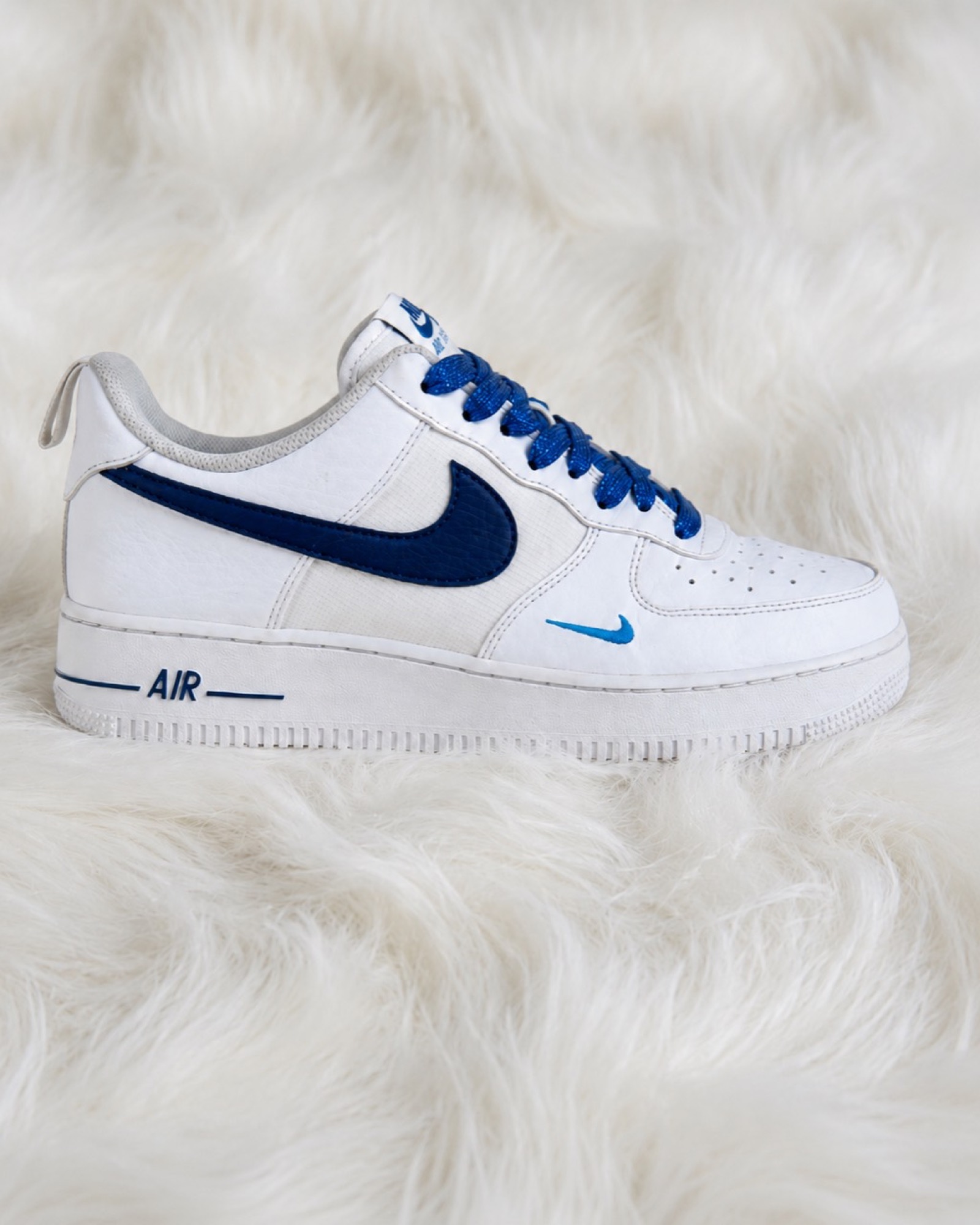 Finished blue and white Air Force 1 custom on a white textured background