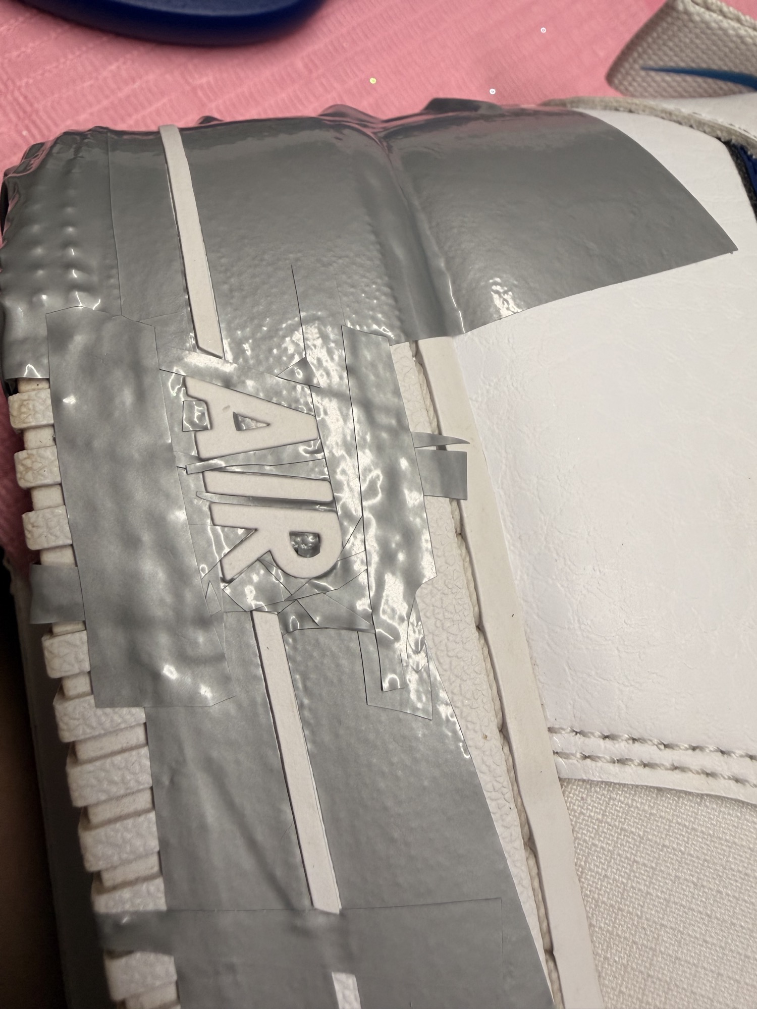 Close-up of precision masking on a blue Air Force 1 custom