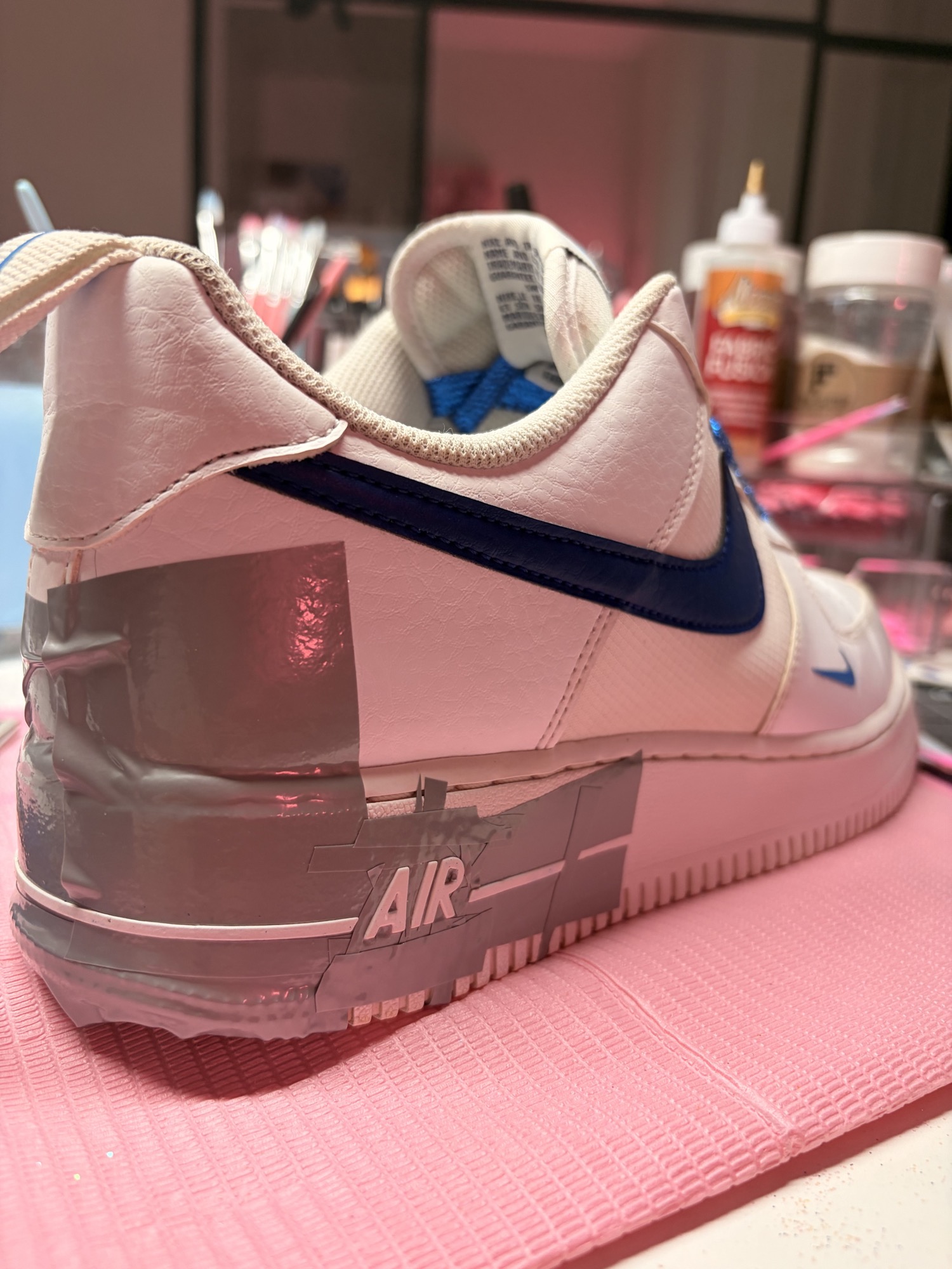 Blue and white sneaker being prepared at the BlingBoxx workbench
