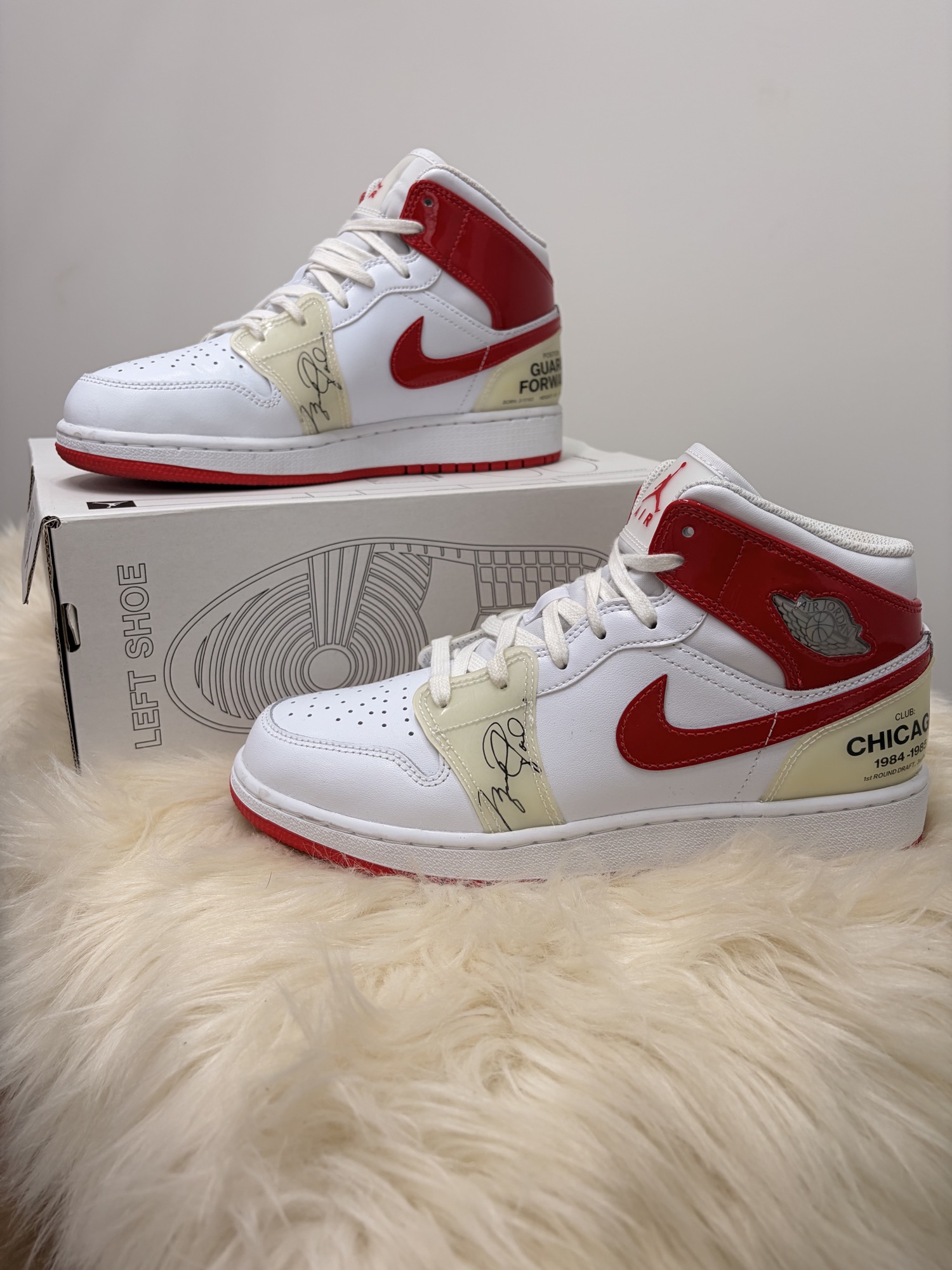 Finished red and white Chicago-inspired custom sneakers with laces displayed on shoe boxes after restoration